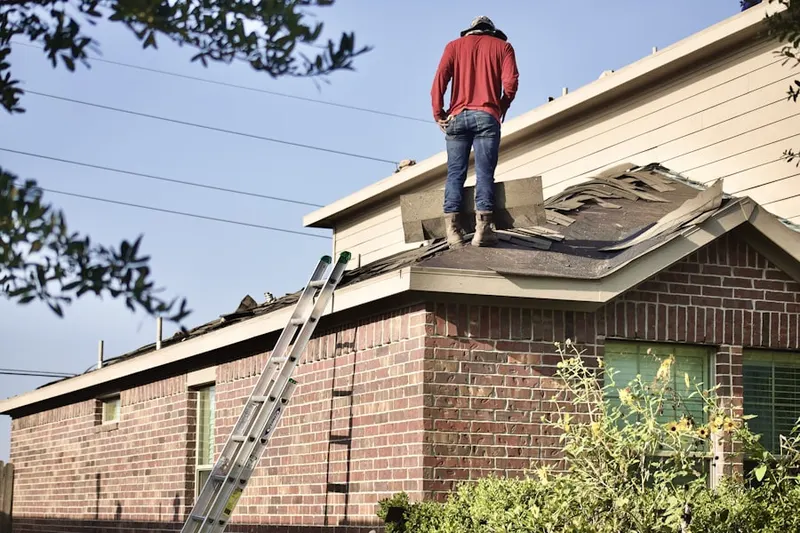 Professional roofer working on a residential roof in Tillicum